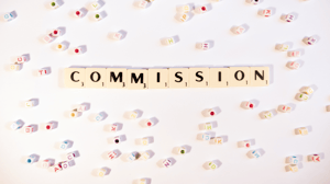 Schriftzug Commission auf hellem Grund
